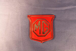 (9) MGB BHH829 SHEILD GRILL BADGE RED ON RED (HONEYCOMBE GRILLE)